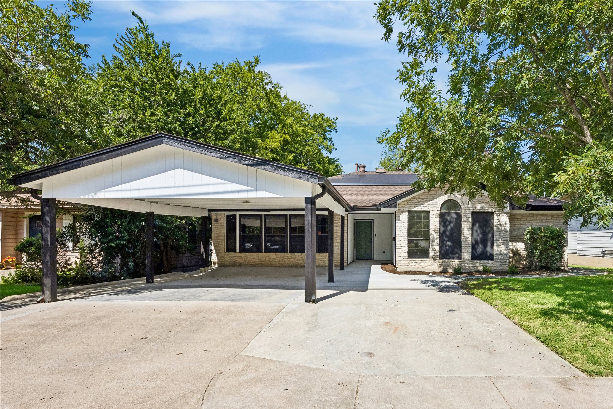 1706 Davis Street Taylor, TX 76574 - Photo 2 of 18 Carport and concrete driveway enhance this residence with mature shade trees.
