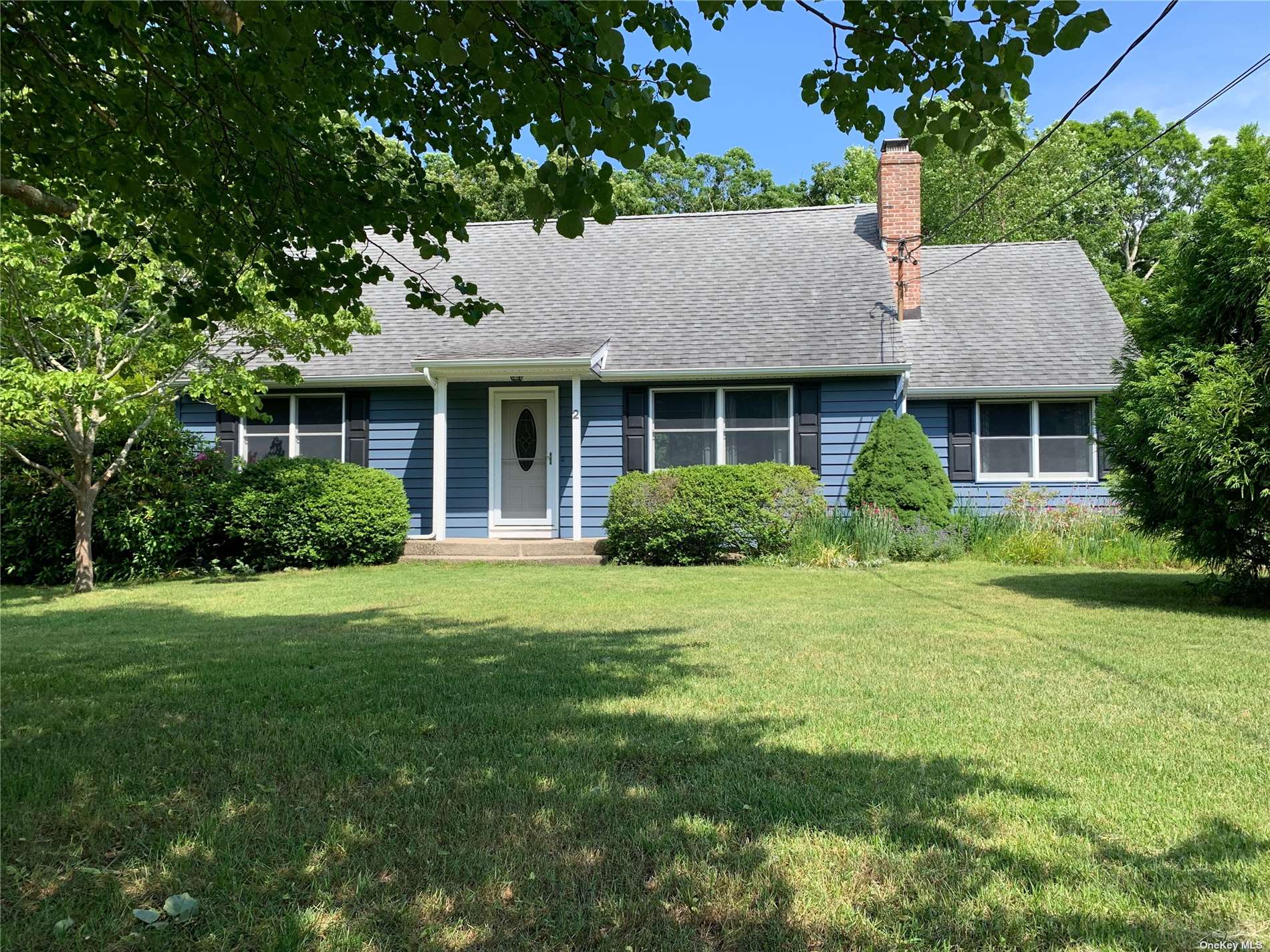 2 Riverview Drive Remsenburg, NY 11960 - Photo 1 of 1 a front view of house with yard and green space