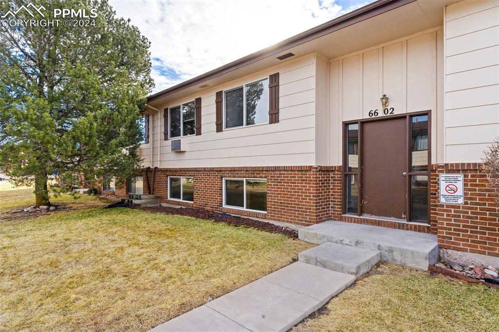 6602 Dublin Loop West, Unit 1 Colorado Springs, CO 80918 - Photo 2 of 23 a view of a house with a yard