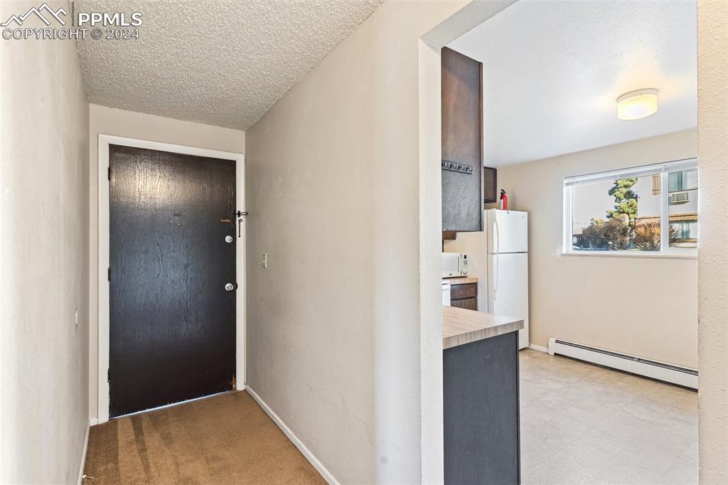 6602 Dublin Loop West, Unit 1 Colorado Springs, CO 80918 - Photo 3 of 23 a view of a kitchen from the hallway
