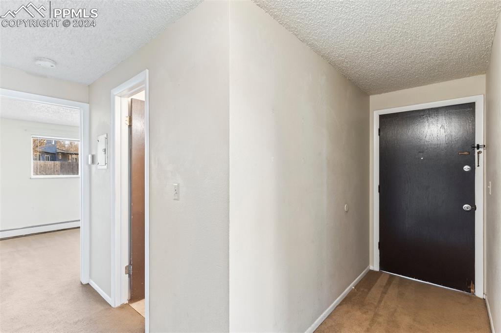 6602 Dublin Loop West, Unit 1 Colorado Springs, CO 80918 - Photo 4 of 23 a view of hallway with closet and wooden floor