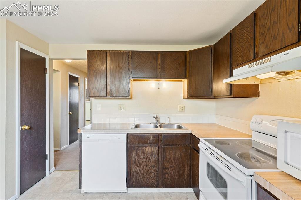 6602 Dublin Loop West, Unit 1 Colorado Springs, CO 80918 - Photo 10 of 23 a kitchen with a sink stove and refrigerator
