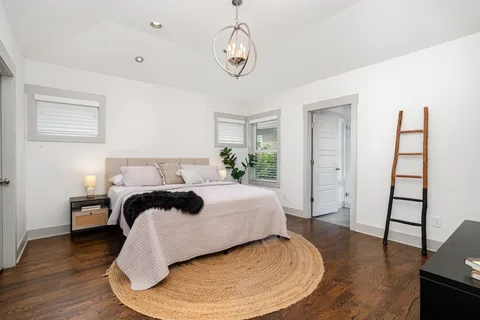 a bedroom with a bed and wooden floor