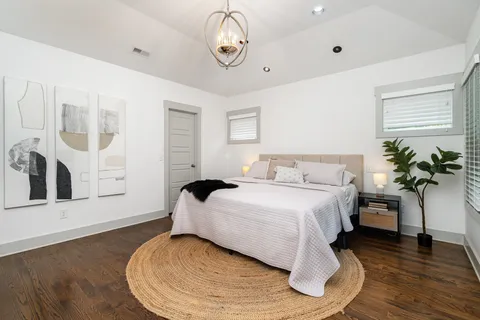 a bedroom with a bed and a potted plant