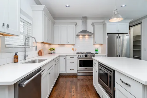 a kitchen with a sink stove and refrigerator