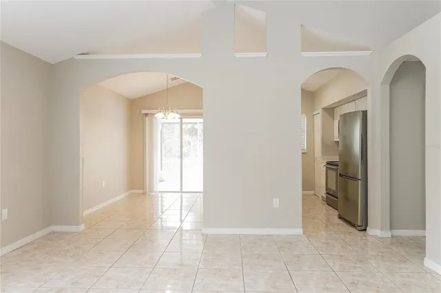 a view of a hallway with wooden floor and a bathroom