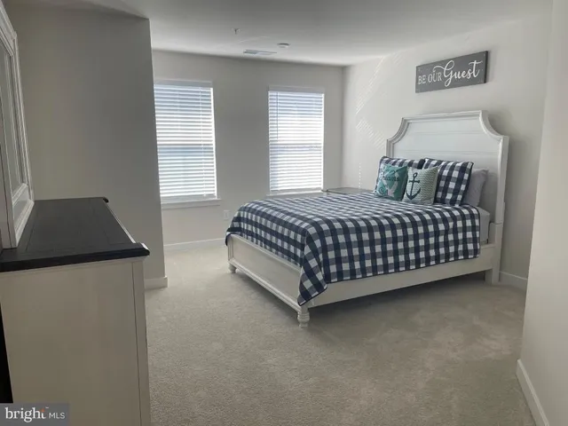 a bedroom with a bed and dresser