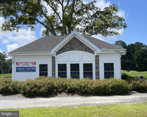 a view of a house with a small yard and a fence