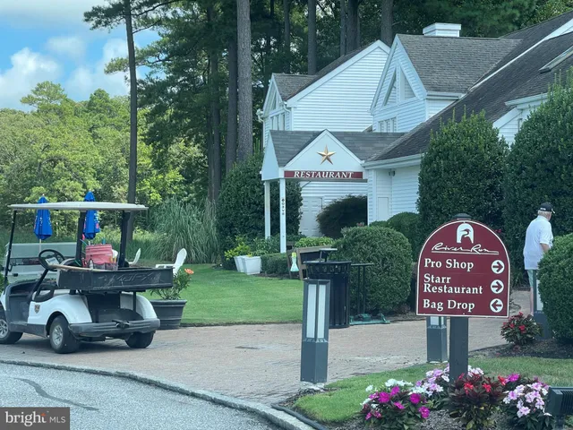 a backyard of a house with lake view and outdoor seating