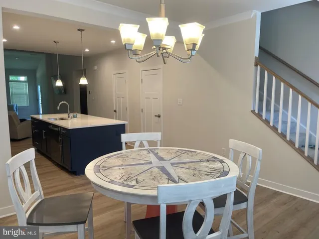 a large kitchen with stainless steel appliances kitchen island granite countertop a large island in the center