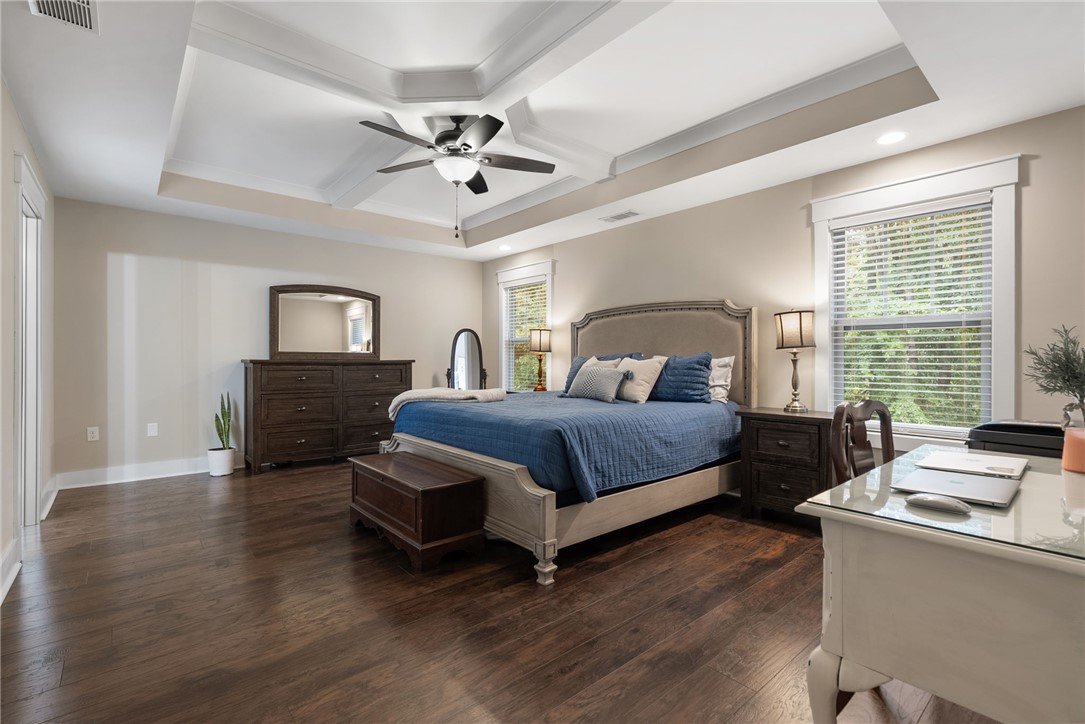 201 Hearthstone Drive Anderson, SC 29621 - Photo 28 of 49 Luxurious primary suite features rich hardwood flooring and a stylish tray ceiling with a modern fan.