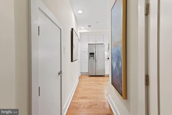 a view of a hallway with walk in closet and living room