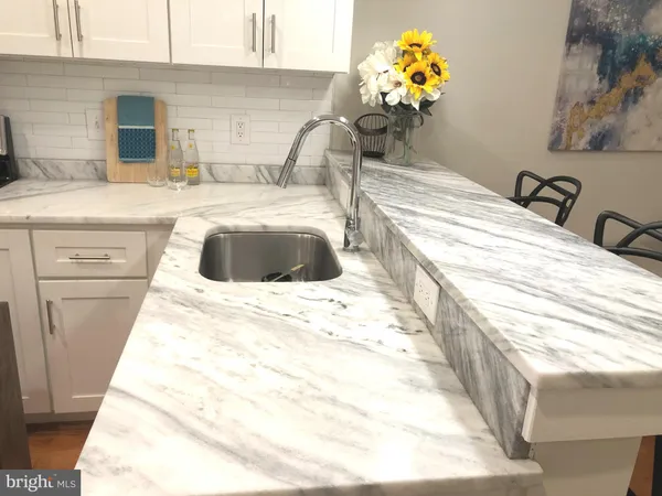 a bathroom with a sink mirror and vanity