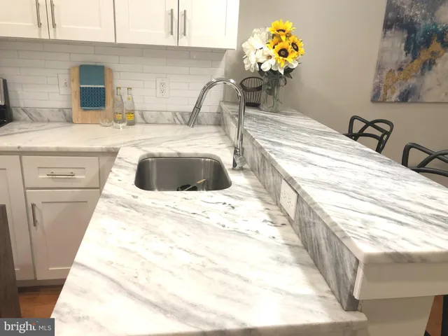 a bathroom with a sink mirror and vanity