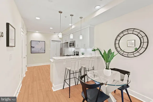 a view of a dining room with furniture and a chandelier