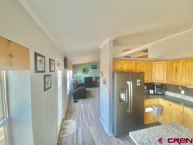a kitchen with stainless steel appliances granite countertop a refrigerator and a sink