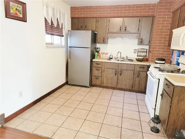 a kitchen with a refrigerator sink stove and cabinets