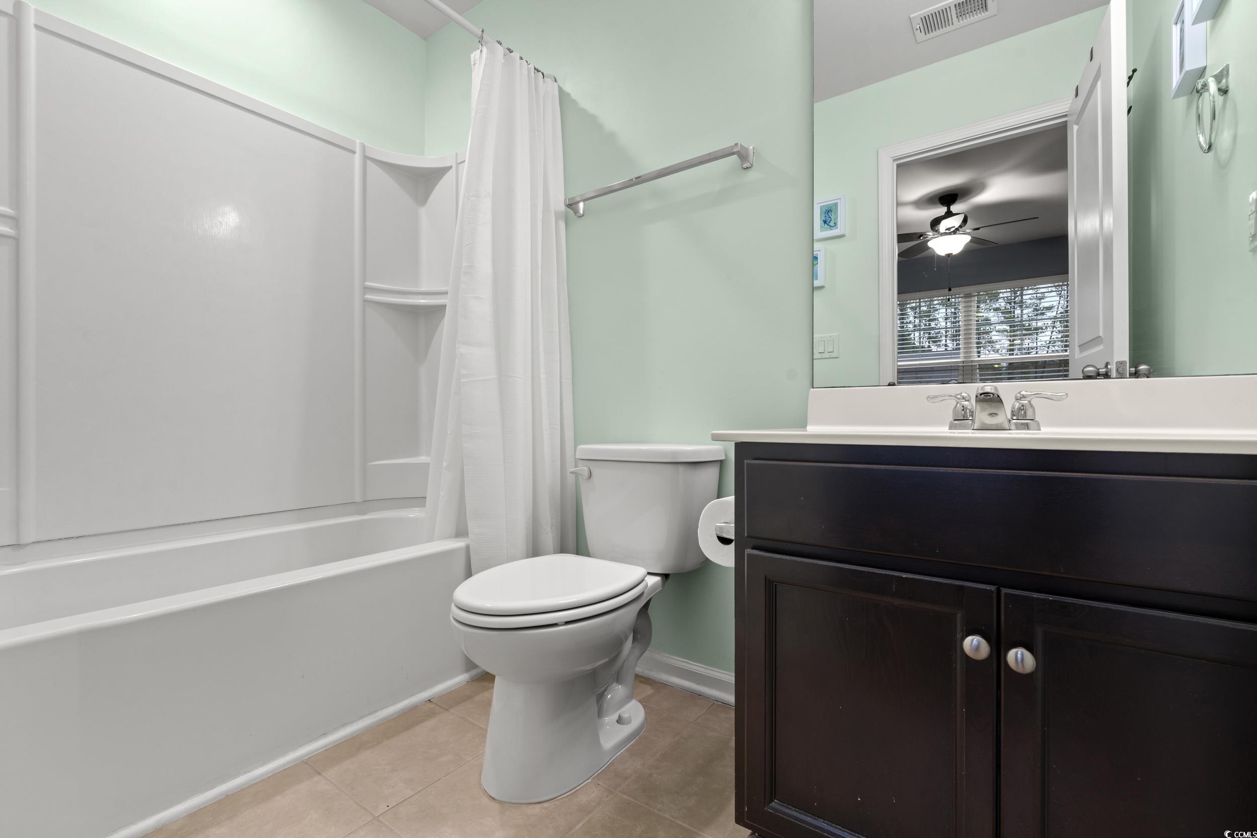 306 Castle Drive, Unit 306 Myrtle Beach, SC 29579 - Photo 19 of 30 Full bathroom featuring shower / tub combo, vanity, light tile patterned floors, and a ceiling fan