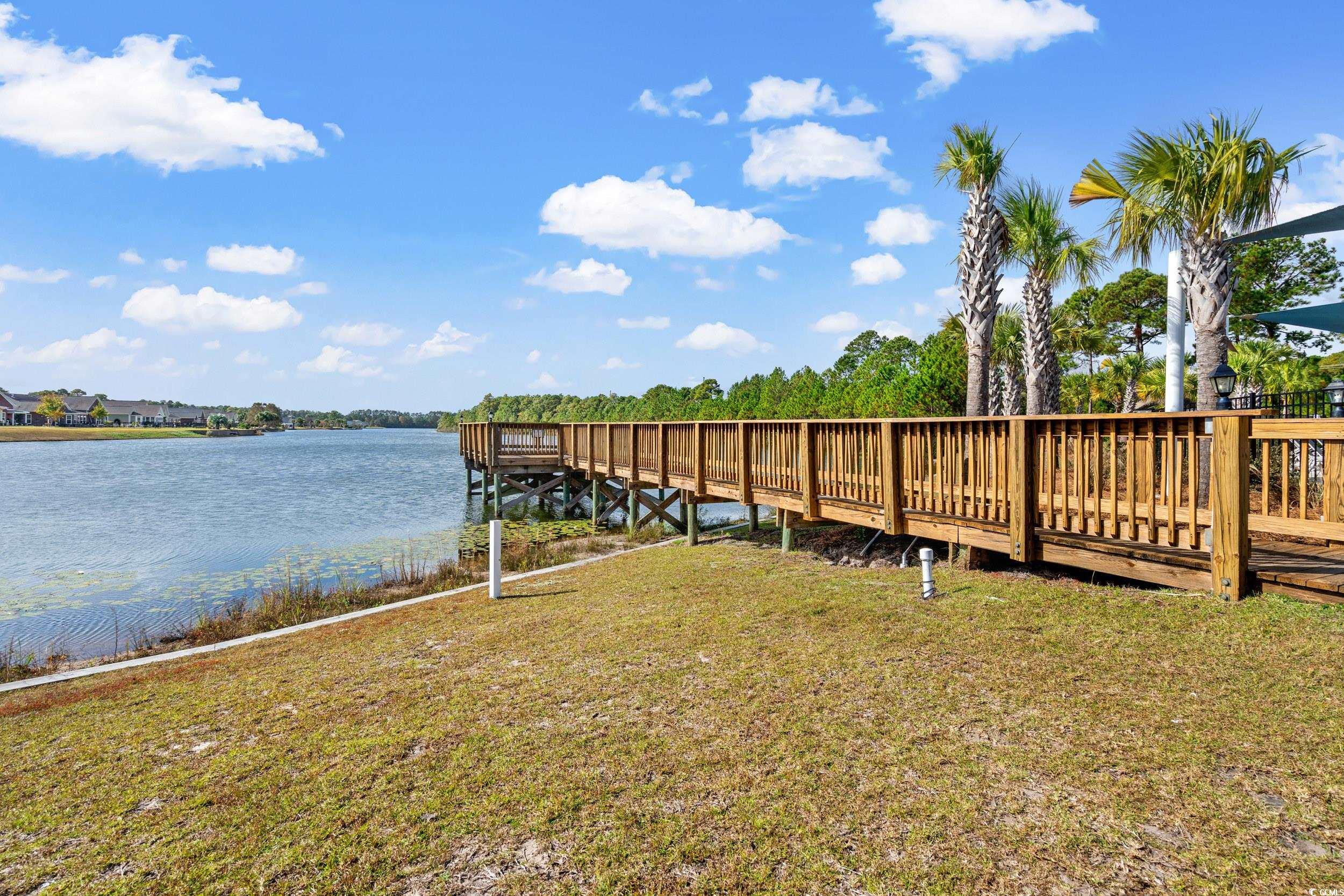 306 Castle Drive, Unit 306 Myrtle Beach, SC 29579 - Photo 26 of 30 Dock area with a yard and a water view