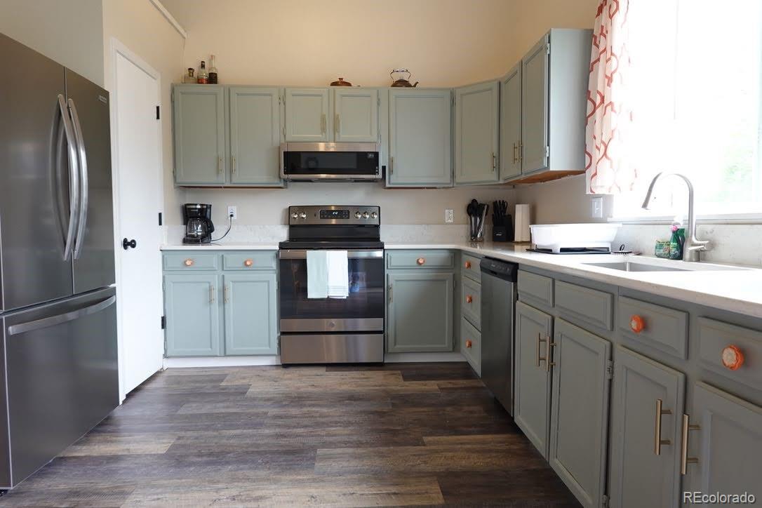 6057 Jay Street Arvada, CO 80003 - Photo 1 of 25 a kitchen with stainless steel appliances granite countertop a refrigerator sink and microwave