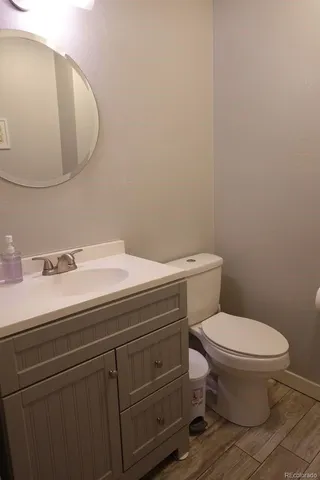 a bathroom with a sink a toilet and mirror