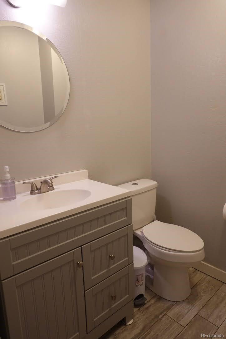 6057 Jay Street Arvada, CO 80003 - Photo 12 of 25 a bathroom with a sink a toilet and mirror