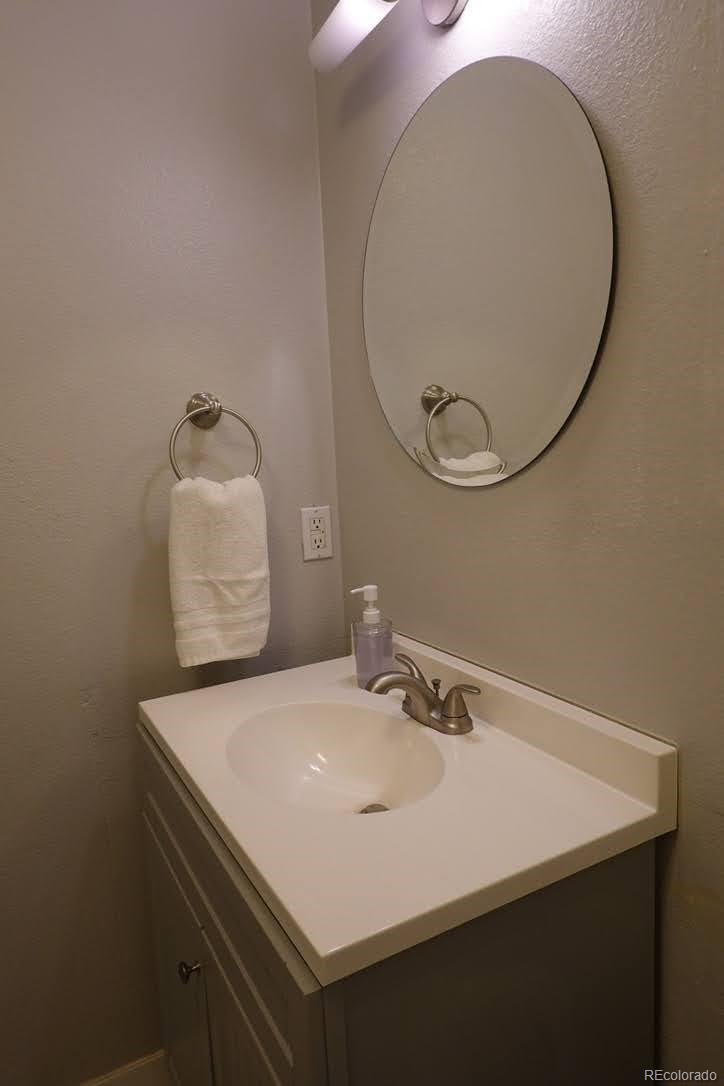6057 Jay Street Arvada, CO 80003 - Photo 13 of 25 a bathroom with a sink and a mirror