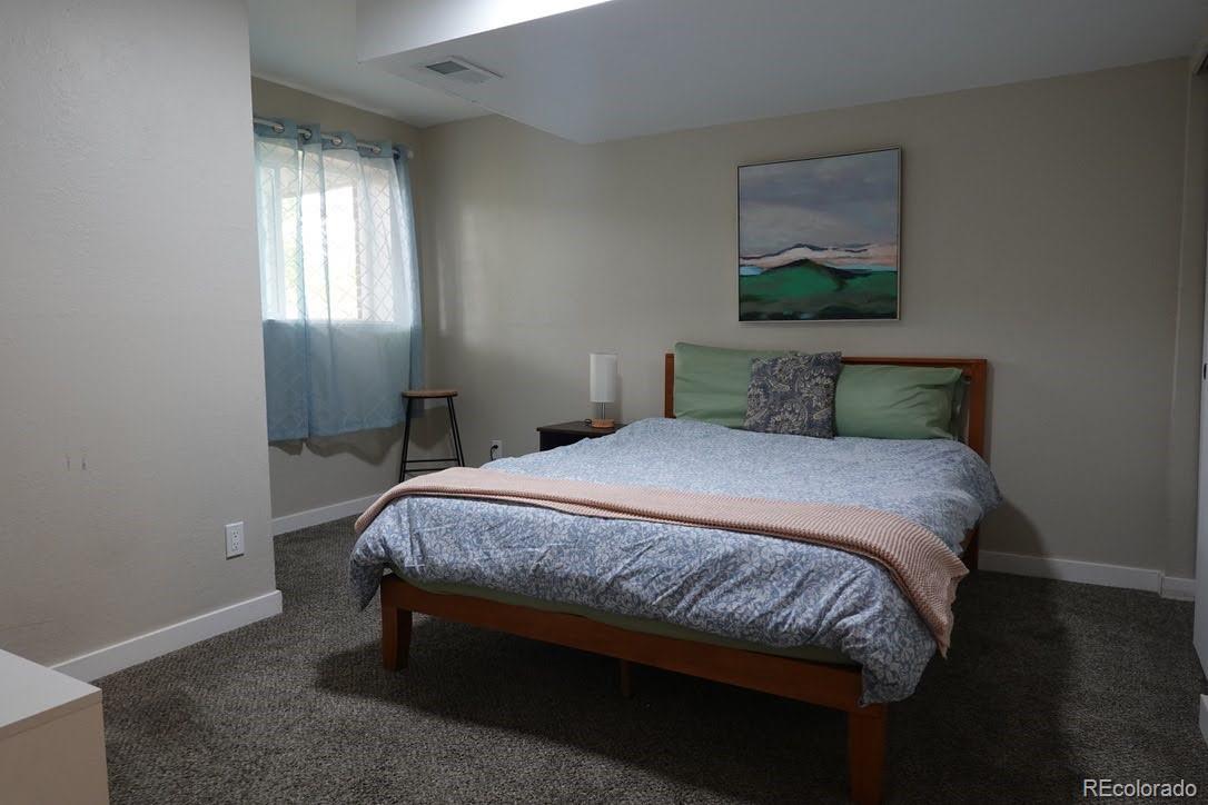 6057 Jay Street Arvada, CO 80003 - Photo 15 of 25 a bedroom with a bed and window
