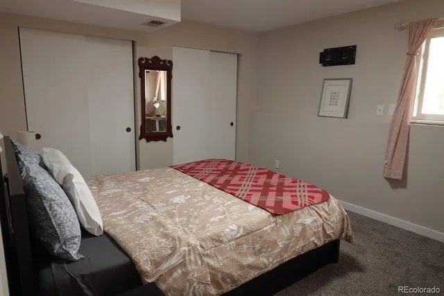 a bedroom with a bed and dresser