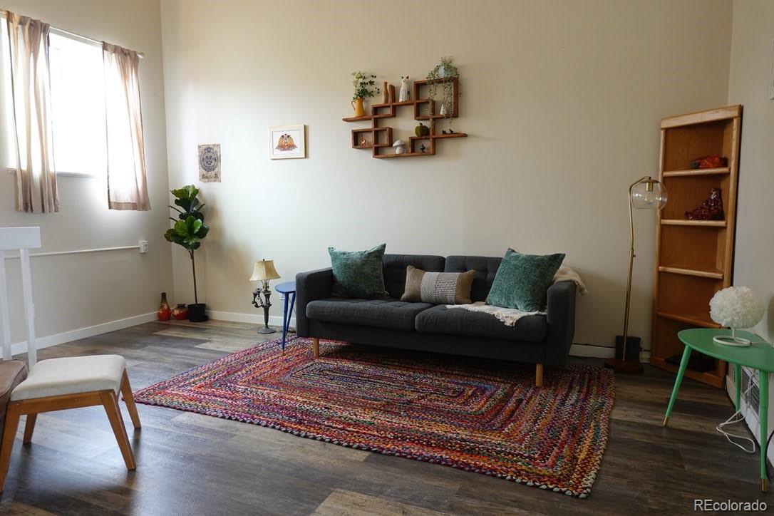 6057 Jay Street Arvada, CO 80003 - Photo 2 of 25 a living room with furniture and a potted plant