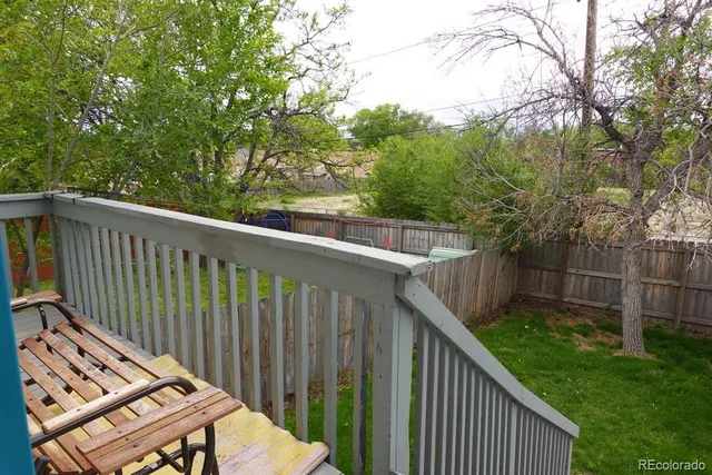 a balcony with trees in front of it