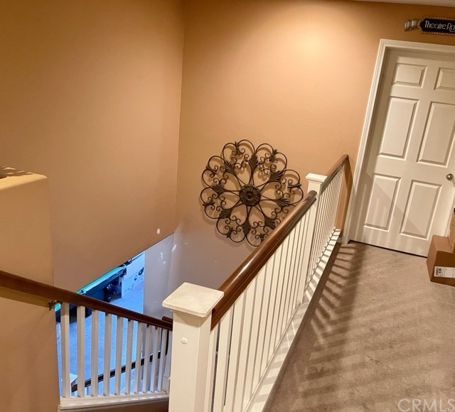 29839 Winter Hawk Road Menifee, CA 92586 - Photo 12 of 21 a view of staircase with railing and a chandelier