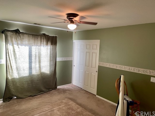 29839 Winter Hawk Road Menifee, CA 92586 - Photo 15 of 21 a view of an empty room with a chandelier fan