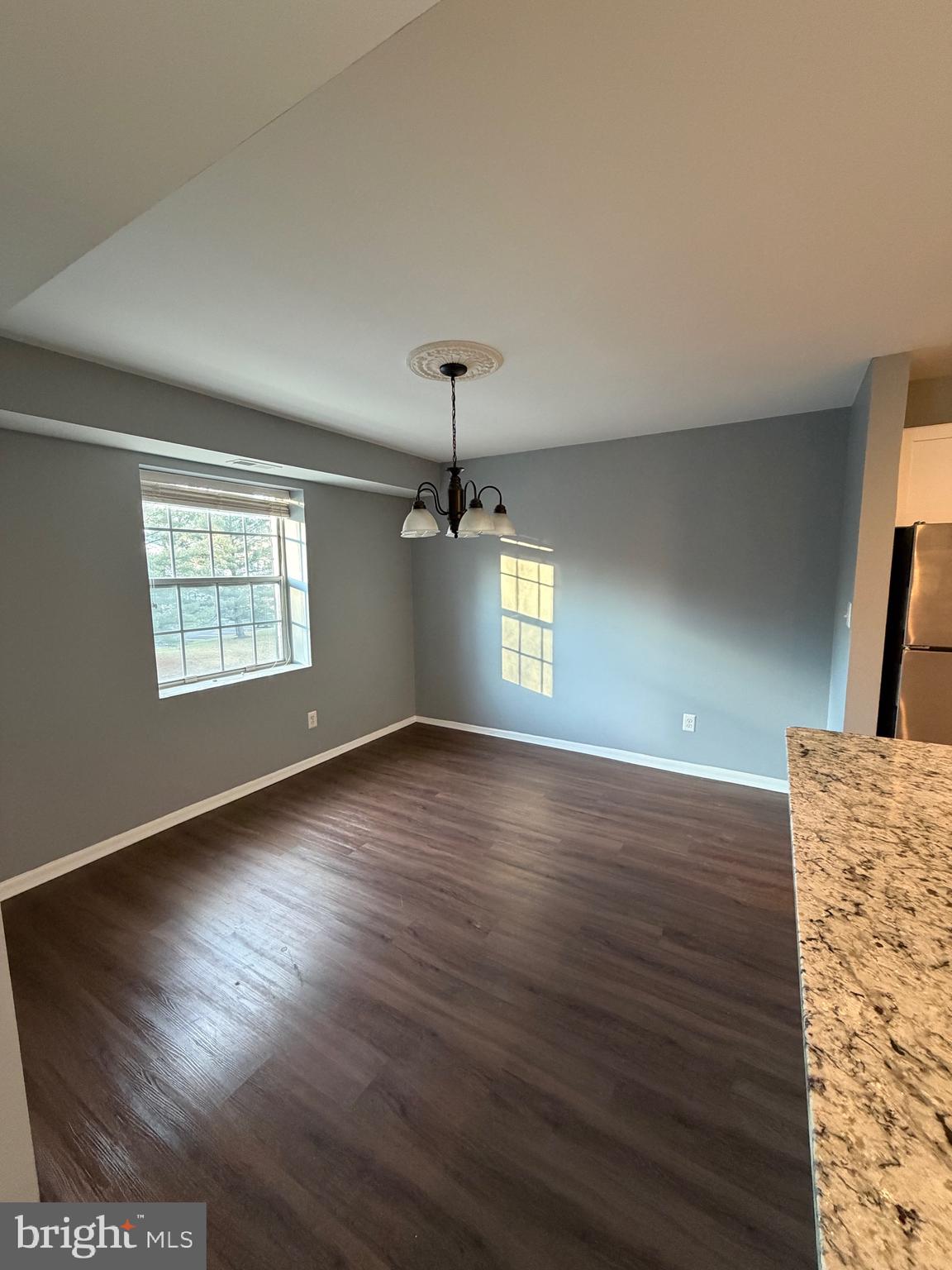 117 Castletown Road, Unit 302 Lutherville-Timonium, MD 21093 - Photo 6 of 15 a view of an empty room with window and wooden floor