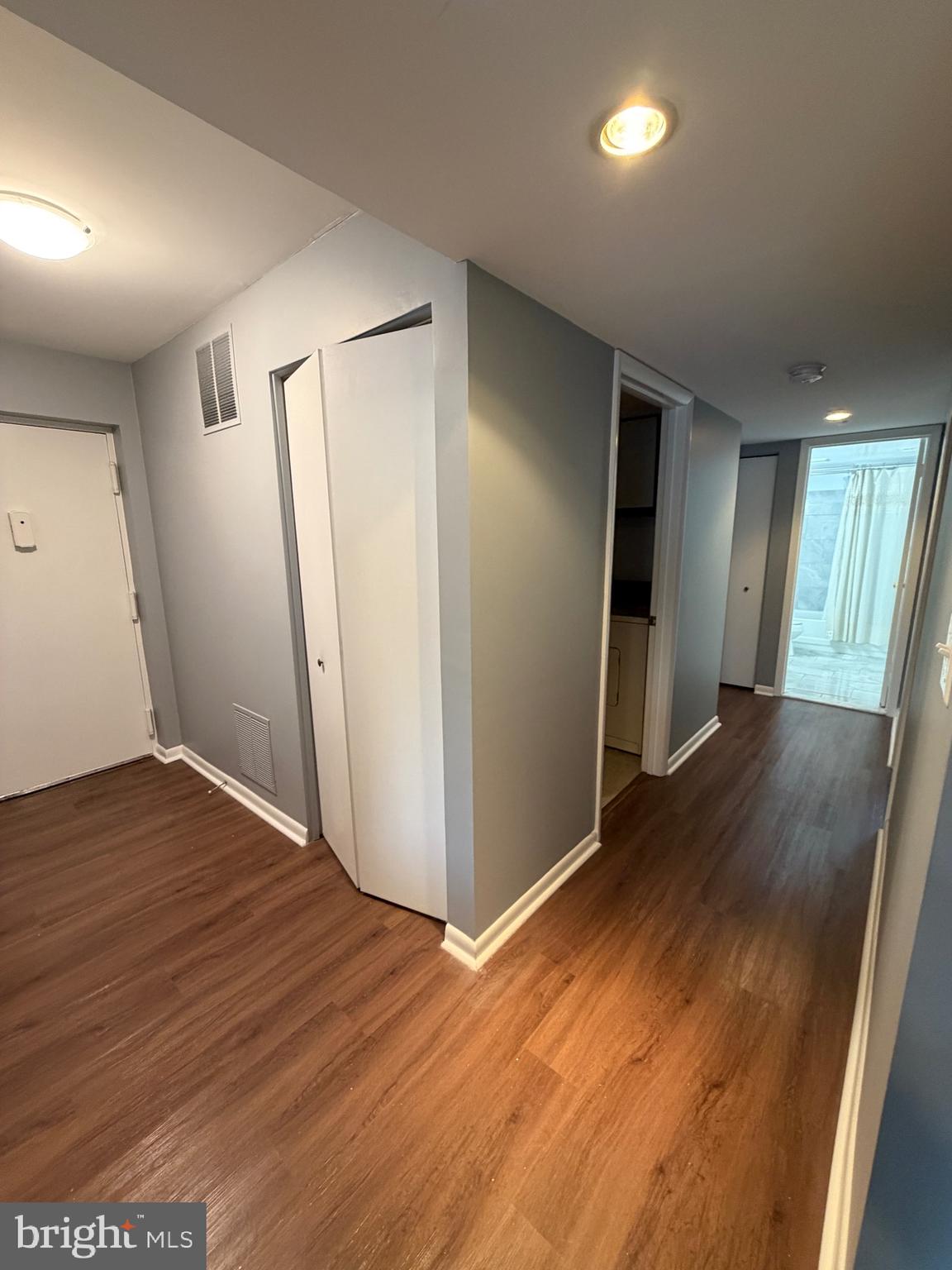 117 Castletown Road, Unit 302 Lutherville-Timonium, MD 21093 - Photo 10 of 15 an empty room with wooden floor and windows