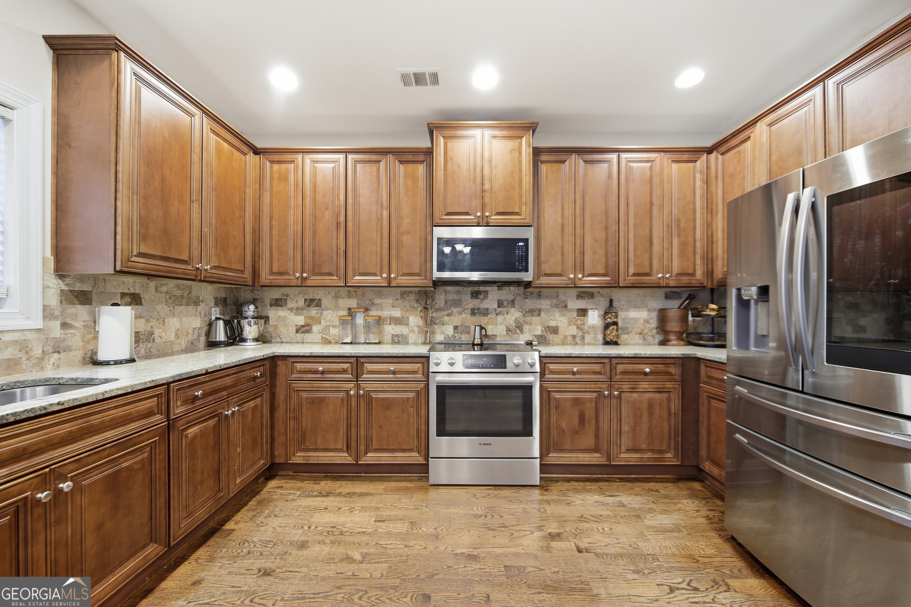 175 Rodgers Road McDonough, GA 30252 - Photo 29 of 84 a kitchen with stainless steel appliances granite countertop a stove top oven sink and cabinets