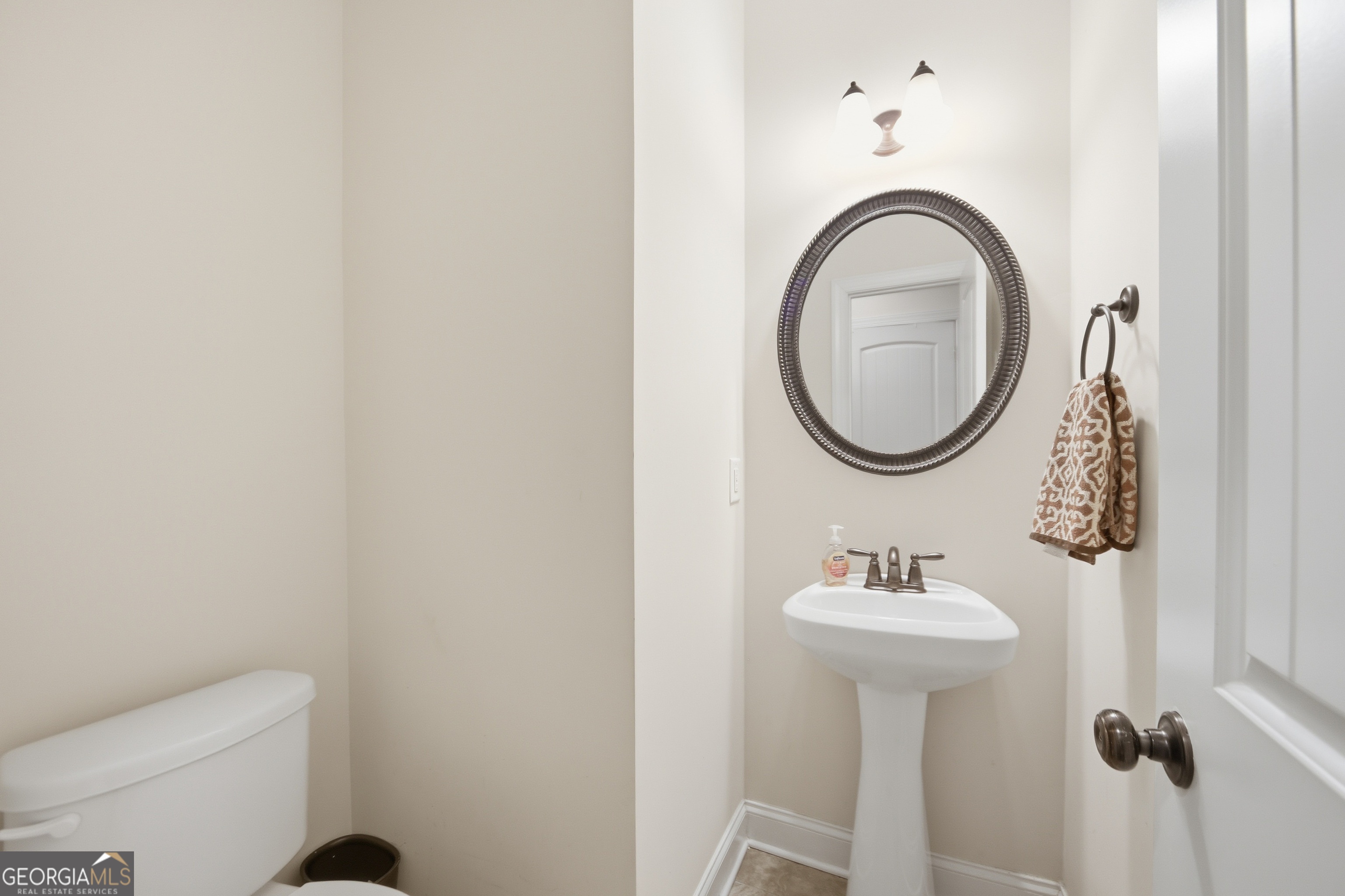 175 Rodgers Road McDonough, GA 30252 - Photo 30 of 84 a bathroom with a sink a mirror and a toilet