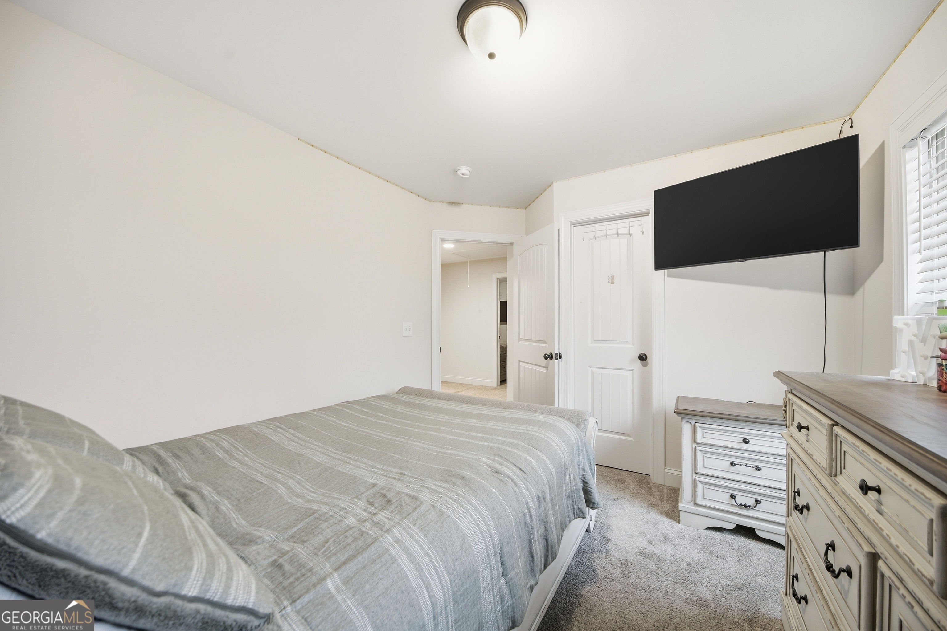 175 Rodgers Road McDonough, GA 30252 - Photo 41 of 84 a bedroom with a bed and a flat tv screen on dresser