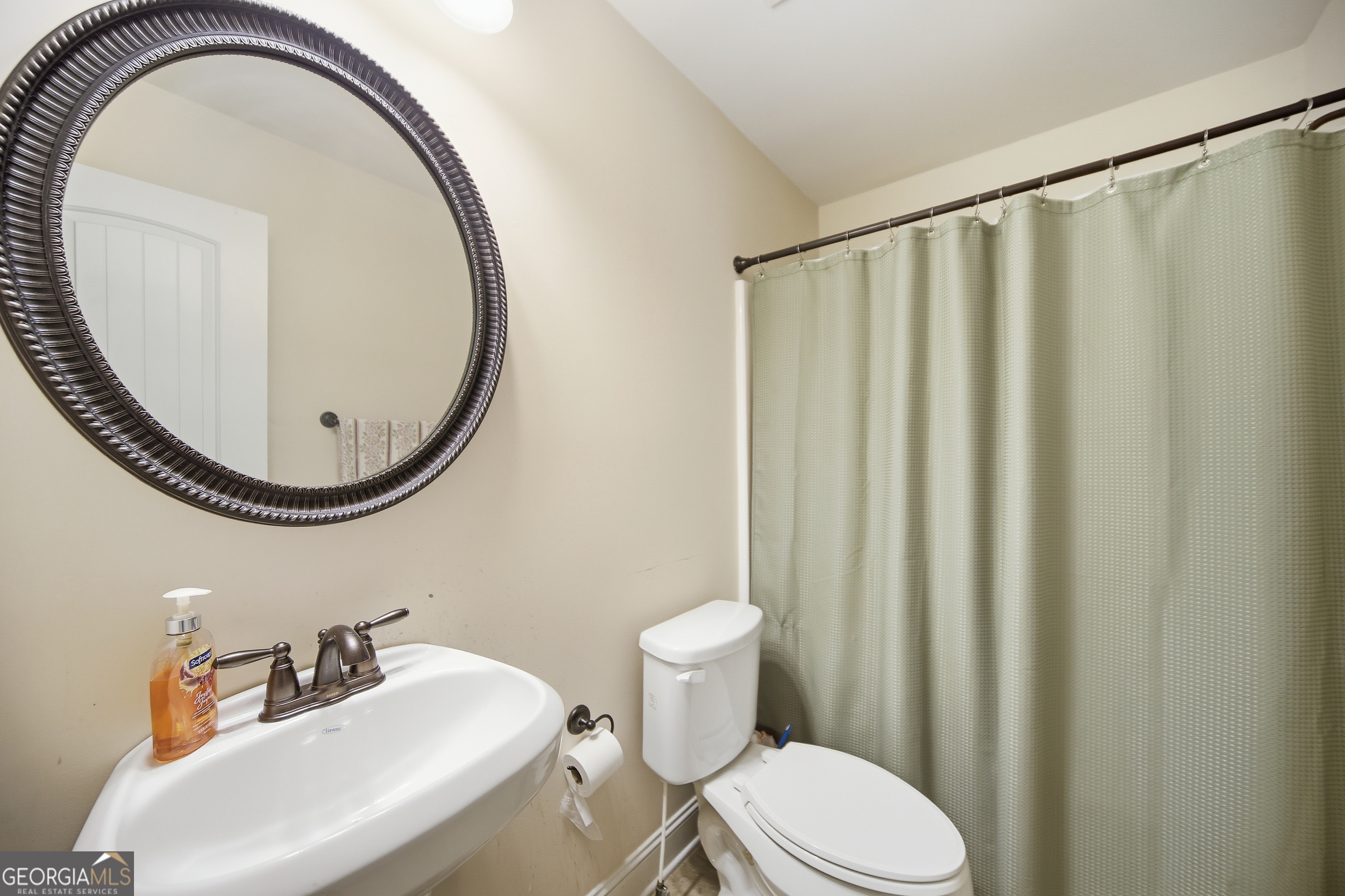 175 Rodgers Road McDonough, GA 30252 - Photo 50 of 84 a bathroom with a sink a mirror a toilet and a mirror
