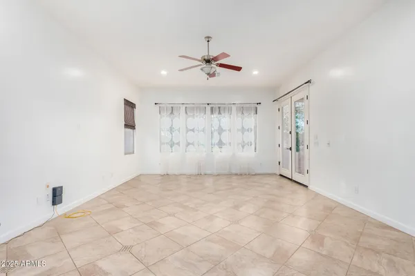 a view of a livingroom with a ceiling fan and window