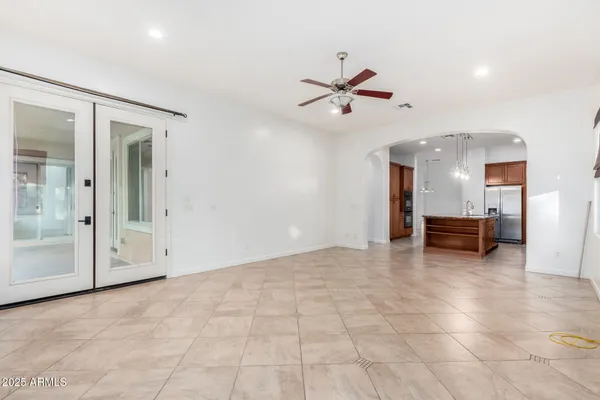 a view of a livingroom with a ceiling fan and window