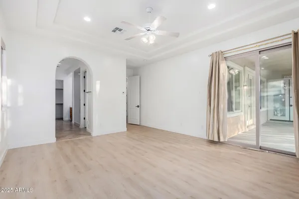 a view of an empty room with glass door