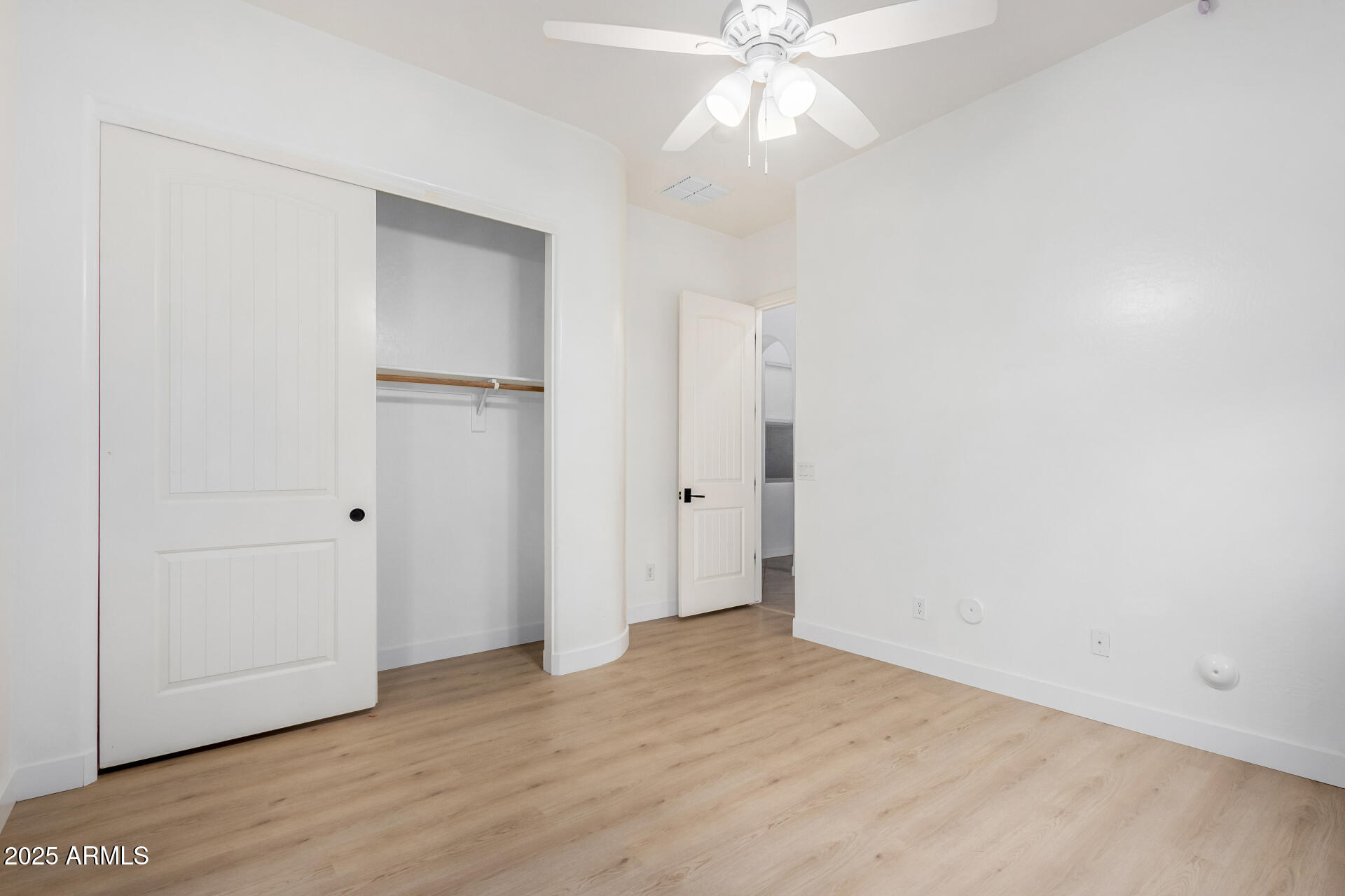 2668 South Stuart Avenue Gilbert, AZ 85295 - Photo 30 of 40 an empty room with wooden floor closet and fan