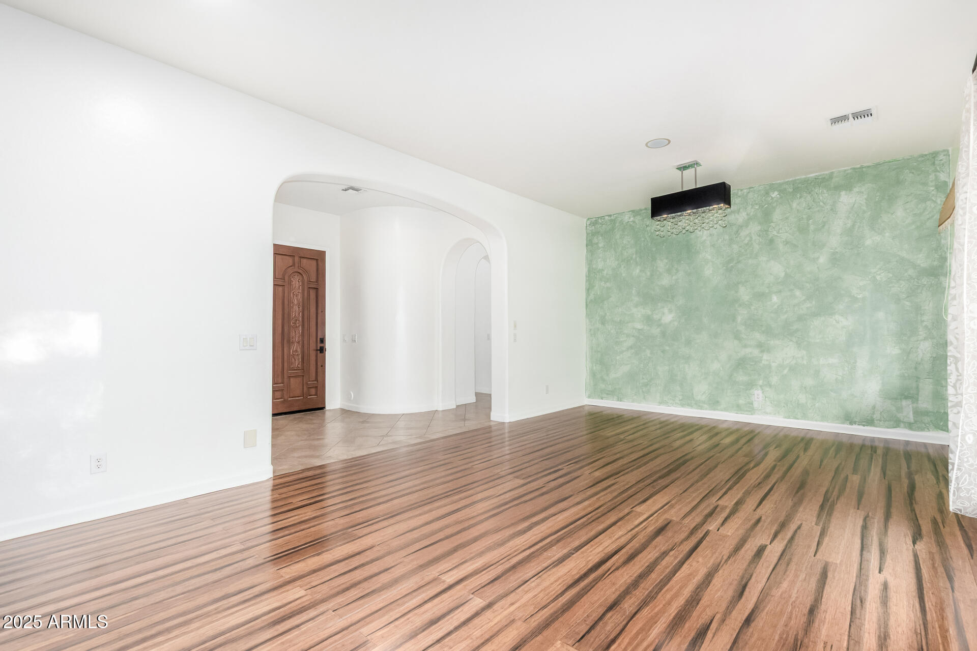 2668 South Stuart Avenue Gilbert, AZ 85295 - Photo 9 of 40 a view of an empty room with wooden floor