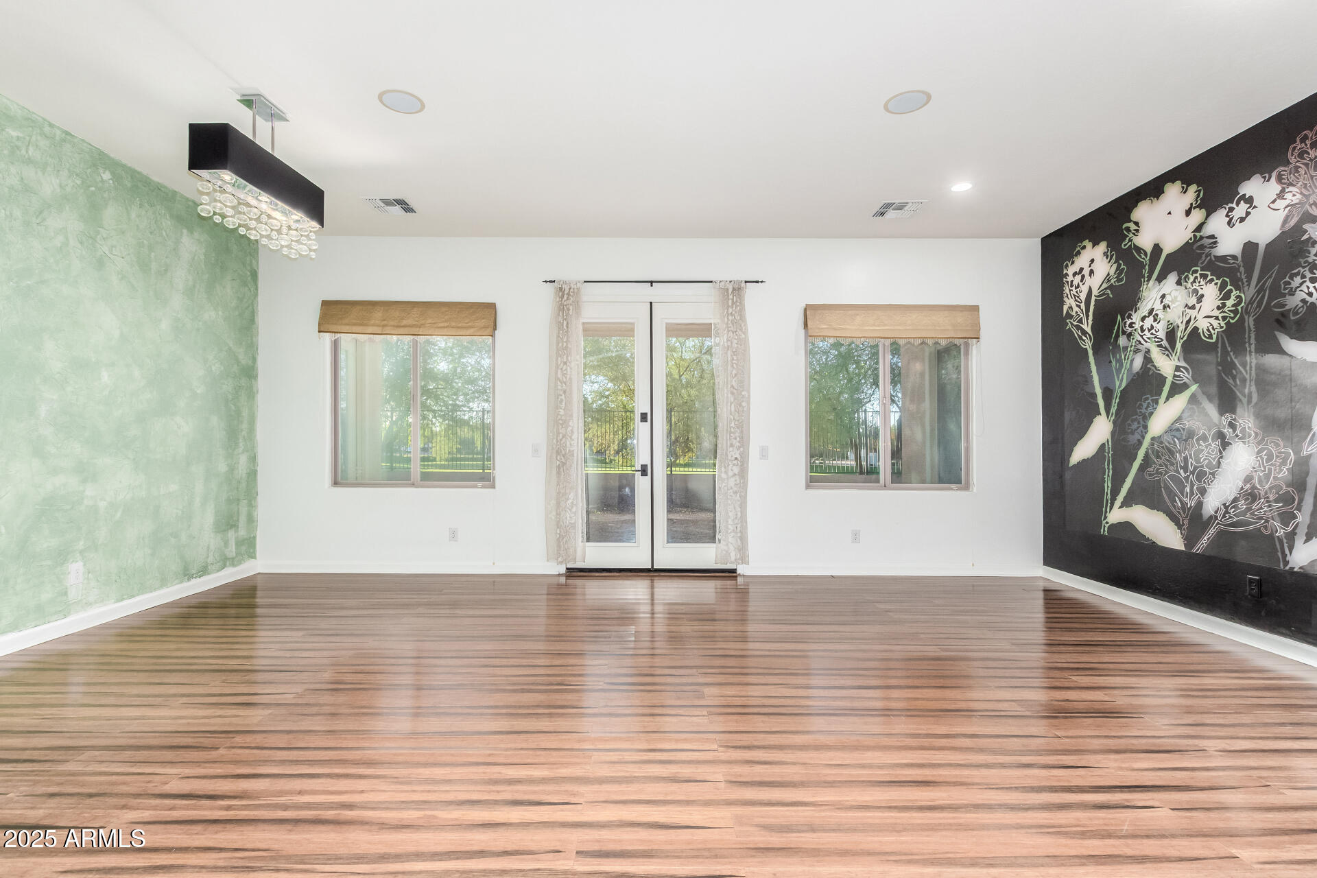 2668 South Stuart Avenue Gilbert, AZ 85295 - Photo 10 of 40 a view of an empty room with wooden floor and a window