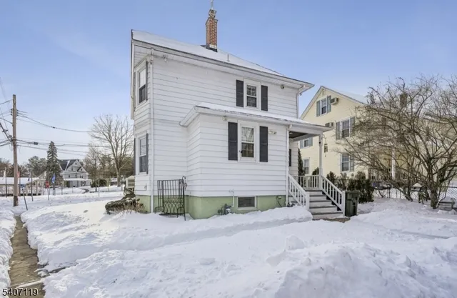 a view of a house with a snow in the yard
