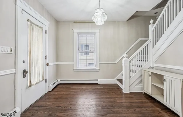 a view of entryway with wooden floor and stair