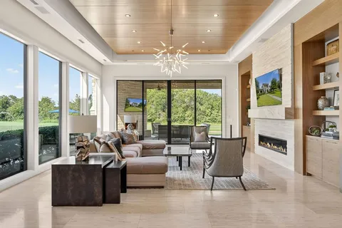 a living room with furniture and large windows