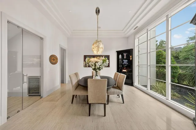 a dining room with furniture a chandelier and wooden floor