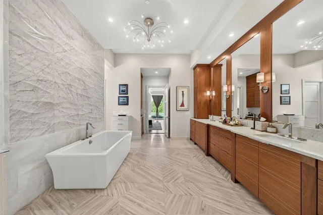 a large spacious bathroom with a double vanity sink a mirror and a bathtub